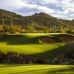 Gorgeous view of the hills leading to the green and saguaro dotted hills on the golf course at the Stone Canyon Club in Tucson Arizona