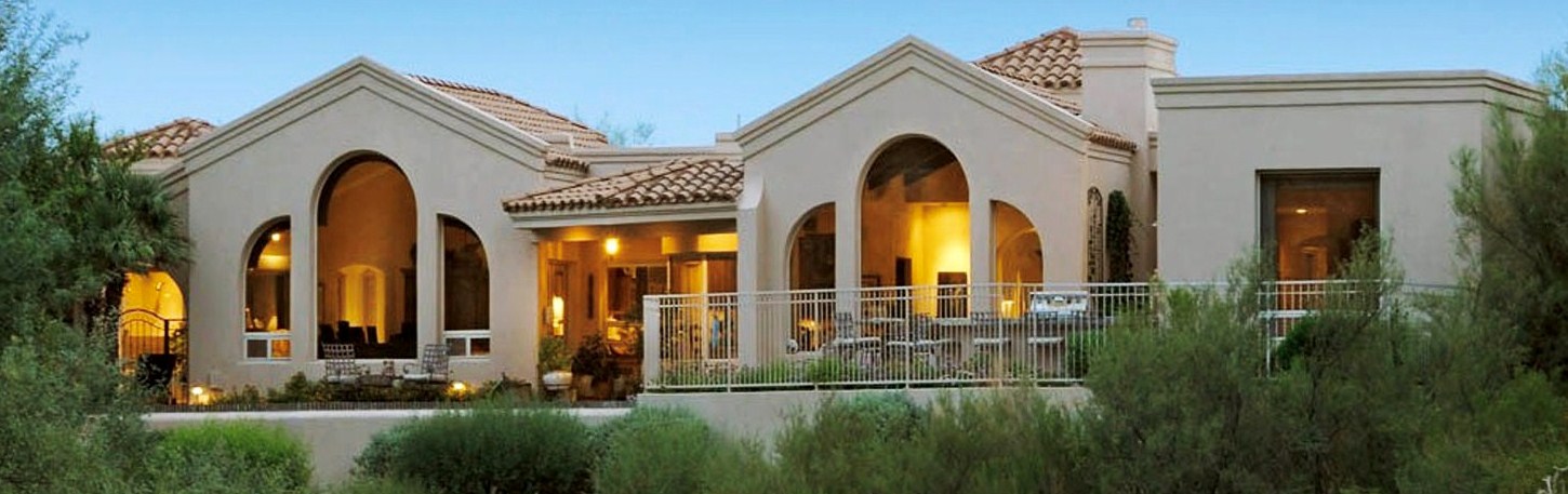 Tucson Golf Estates - Lights shining inside of a golf home overlooking a golf course in Arizona