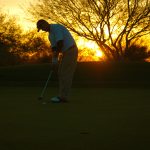 Playing golf at sunset on the OMNI Tucson National Golf Course in Tucson, Arizona